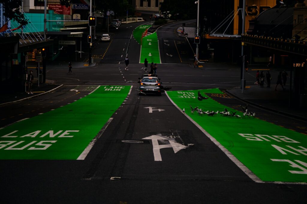 a car driving down a street with green markings