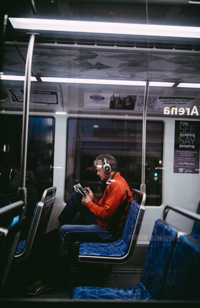 man sitting inside train while reading