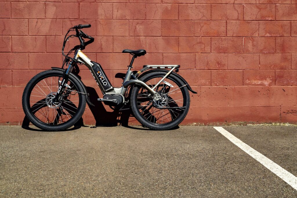 A Bike Parked Beside Brick Wall