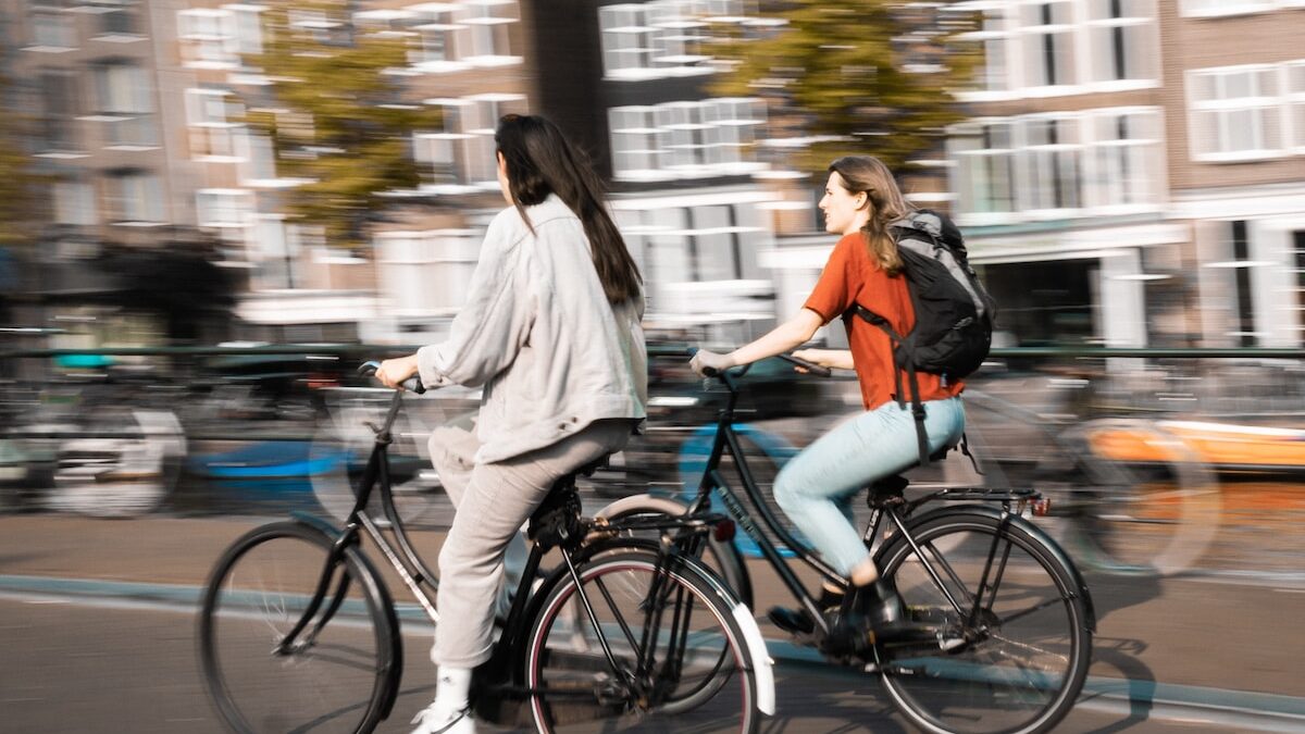 two women riding bicycles