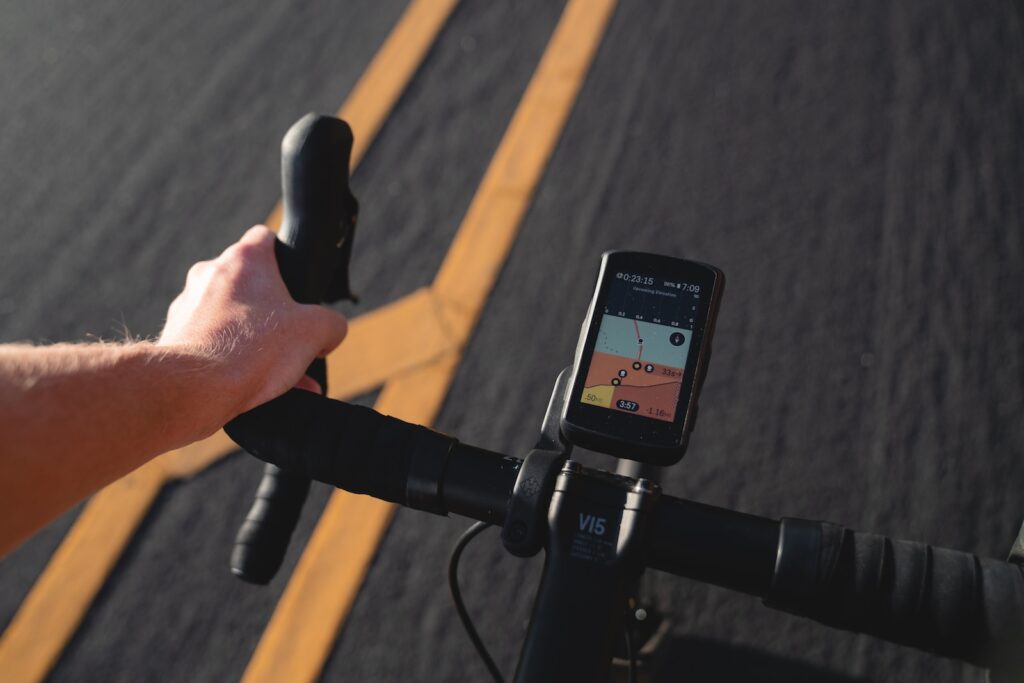 a person riding a bike with a gps app on the handlebars