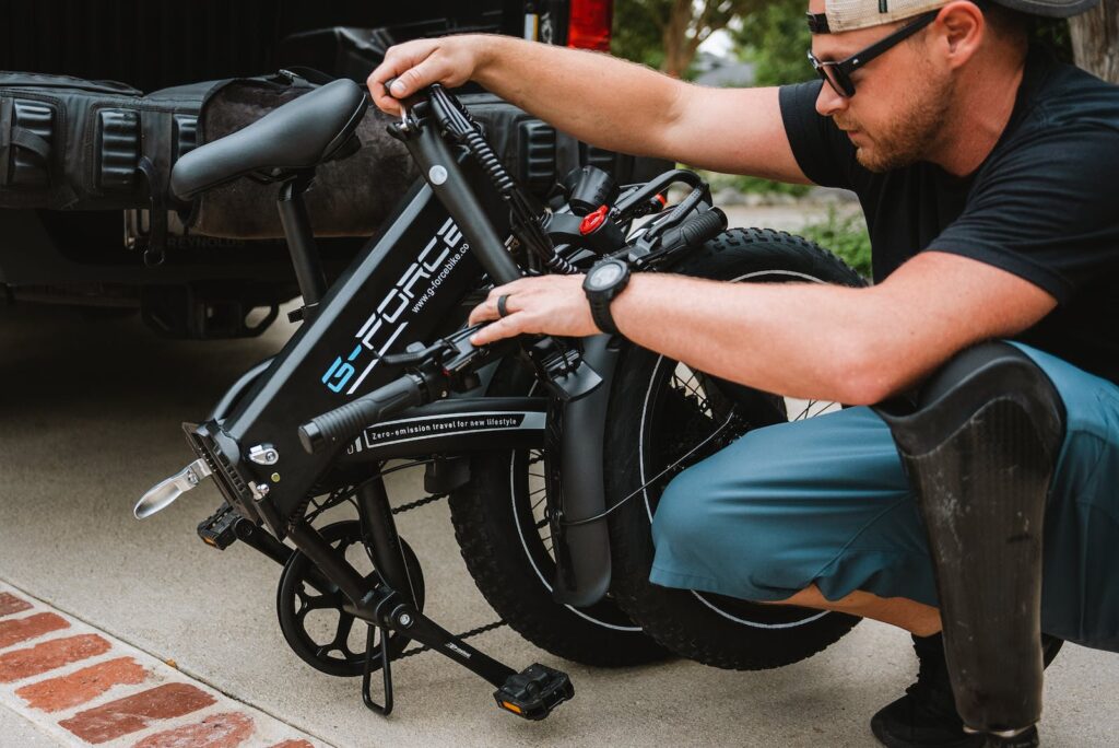 A Man Holding His Folding Bike