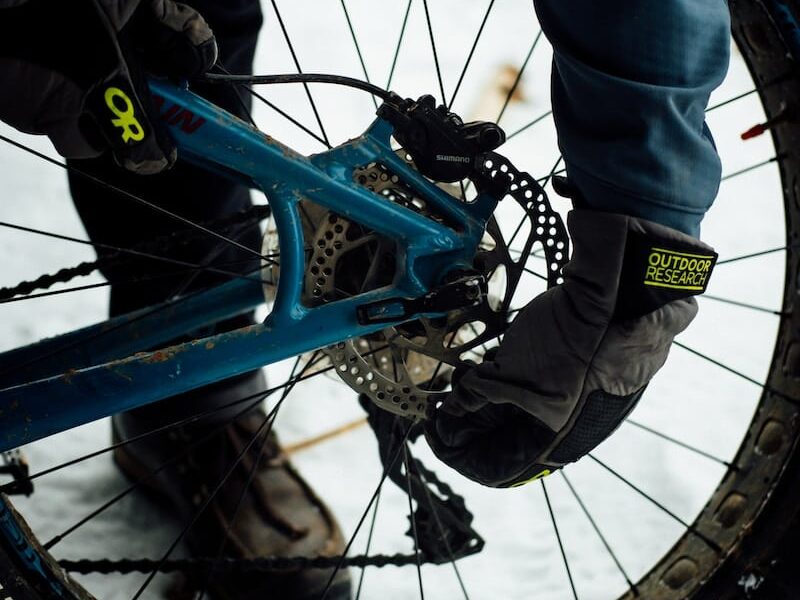 a close up of a person riding a bike in the snow